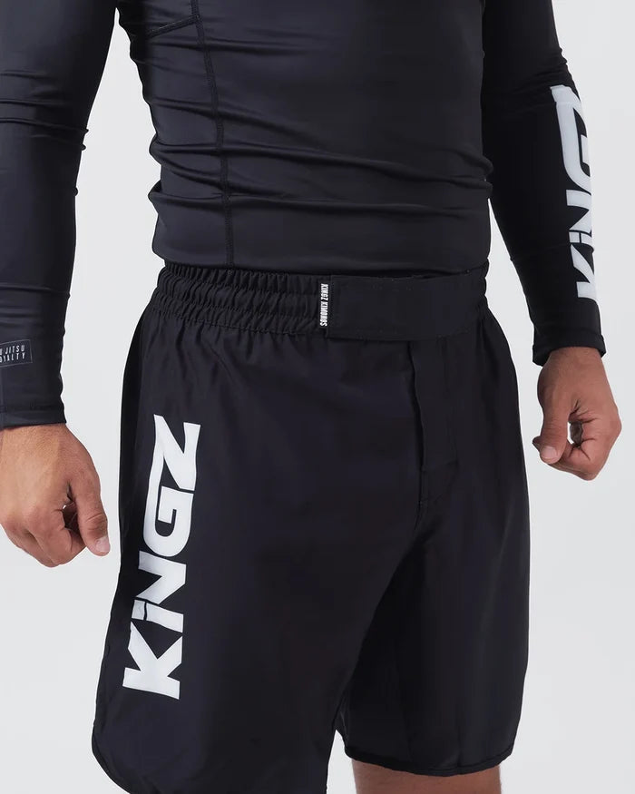 Kingz Kore V2 Shorts Black - Close Up Left Thigh Detail Large KINGZ White Vertical Text Left Outer Thigh KINGZ KIMONOS Small Text Elastic Waistband Black Lightweight Grappling Fabric Men's No-Gi BJJ MMA Kore Collection [color:Black]