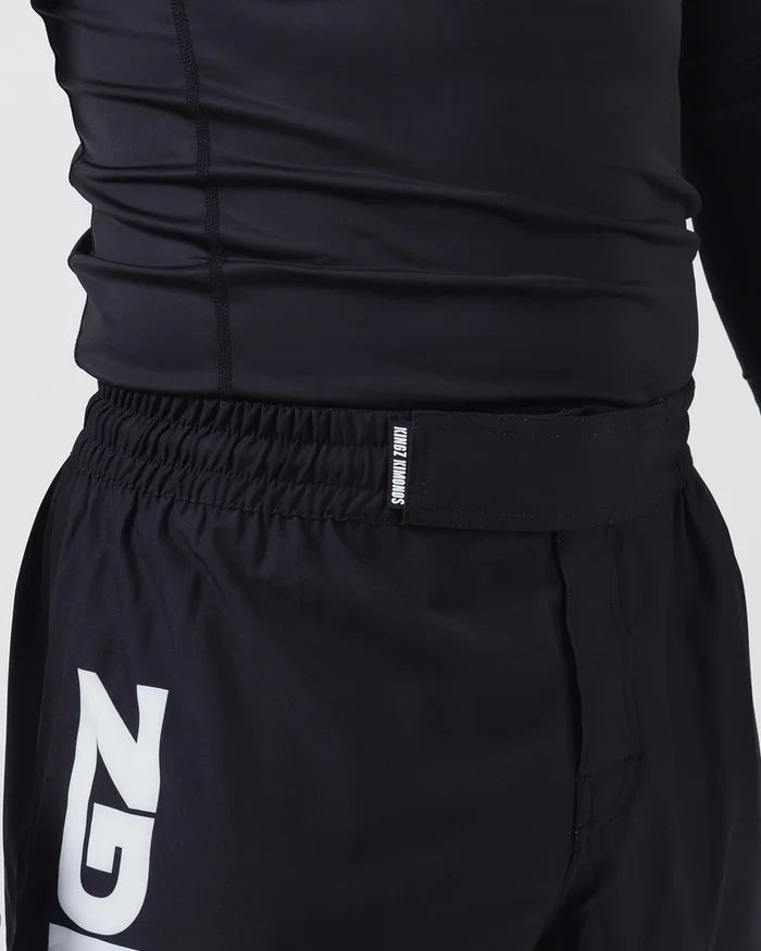 Kingz Kore V2 Shorts Black - Close Up Waistband and Upper Thigh KINGZ KIMONOS White Text Elastic Waistband Large KINGZ White Logo Left Outer Thigh Black Lightweight Grappling Fabric Men's No-Gi BJJ MMA Kore Collection [color:Black]