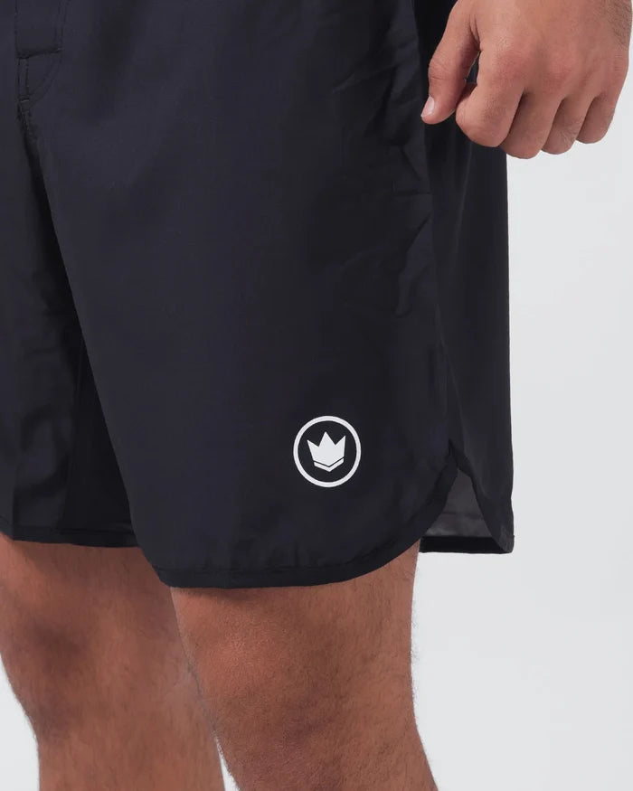 Kingz Kore V2 Shorts Black - Close Up Right Thigh Detail White Outlined Crown Logo Emblem Right Outer Thigh Side Vent Slit Hem Hand Gripping Waistband Black Lightweight Grappling Fabric Competition Cut Men's No-Gi BJJ MMA Kore Collection [color:Black]