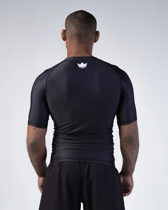 Kingz Kore V2 Short Sleeve Rashguard Black - Back View Male Athlete White Crown Logo Upper Back Sleek Fit Smooth Fabric BJJ Training Rash Guard [color:Black]
