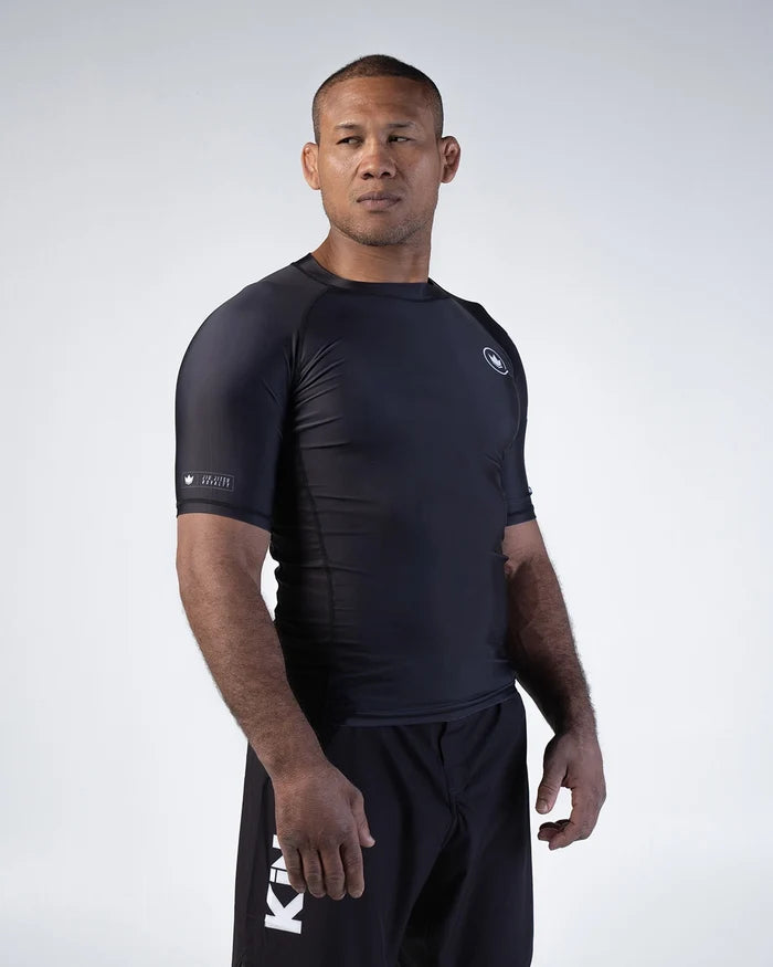 Kingz Kore V2 Short Sleeve Rashguard Black - Front View Male Athlete Black Crown Logo Left Chest Sleeve Patch Fitted Design BJJ Grappling Rash Guard [color:Black]
