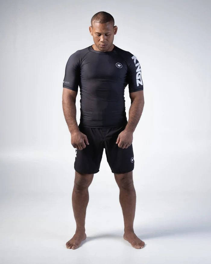 Kingz Kore V2 Short Sleeve Rashguard Black - Full Body Front View Male Athlete Black Crown Logo Left Chest Large KINGZ Text Left Sleeve Compression Fit BJJ No-Gi Grappling Rash Guard [color:Black]