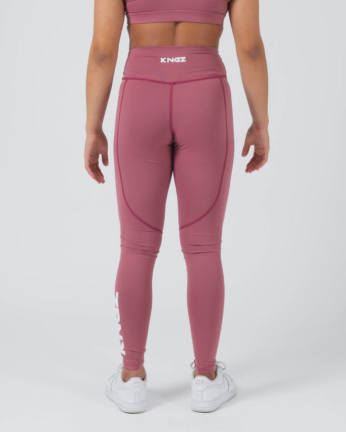 Kingz Kore Women's Grappling Spats Red - Full Body Back View Female Athlete Dusty Rose Mauve KINGZ White Text Back Waistband KINGZ Vertical Text Right Leg Side Pocket Seam High-Waist Compression Fit Women's No-Gi BJJ Spats Kore Collection [color:Dusty Rose]