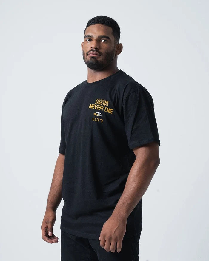 Kingz Legends Never Die Tee Black - Three Quarter View Male Athlete Yellow Legends Never Die Text Left Chest Black Cotton Short Sleeve Casual Fit T-Shirt BJJ Training Apparel [color:Black]