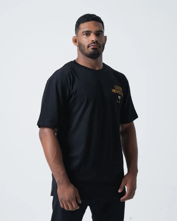 Kingz Legends Never Die Tee Black - Front View Male Athlete Gold Text Left Chest Short Sleeve Relaxed Fit BJJ Training Apparel [color:Black]