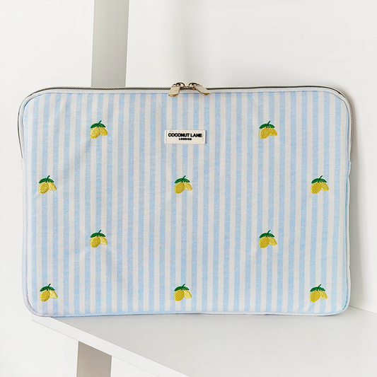 Laptop sleeve with bright yellow lemon print on a white background by Coconut Lane.