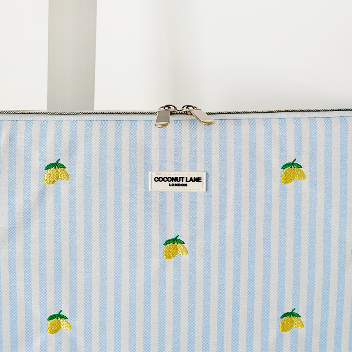 Blue and white striped laptop sleeve with embroidered lemons, by Coconut Lane.