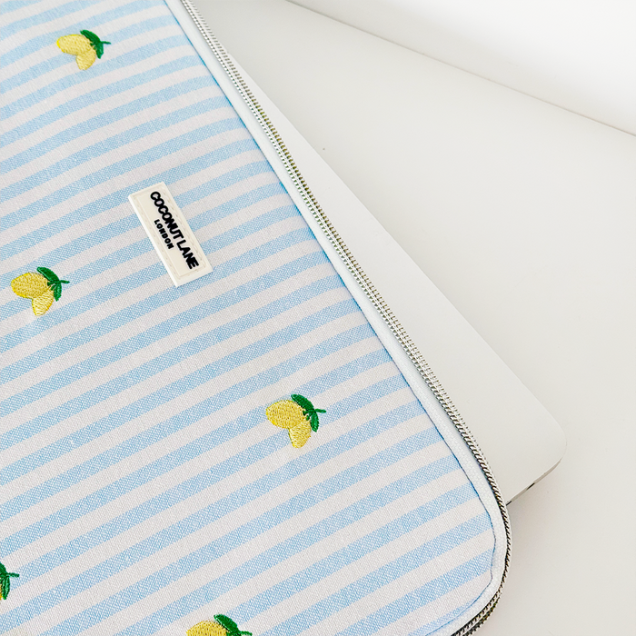 Laptop sleeve with blue and white stripes and small lemon patterns, from Coconut Lane’s Living La Vida Lemon collection.