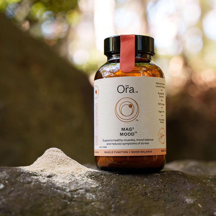 150g jar Ora Mag3 Mood placed on a rock, vegan supplement to support muscles, mood balance, and reduce symptoms of stress.