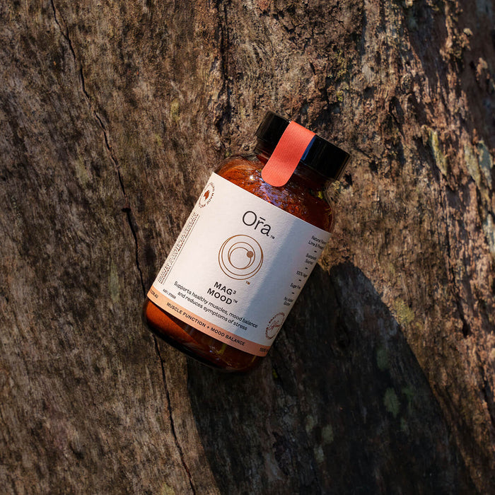 150g jar Ora Mag3 Mood placed on bark, vegan supplement to support muscles, mood balance, and reduce symptoms of stress.