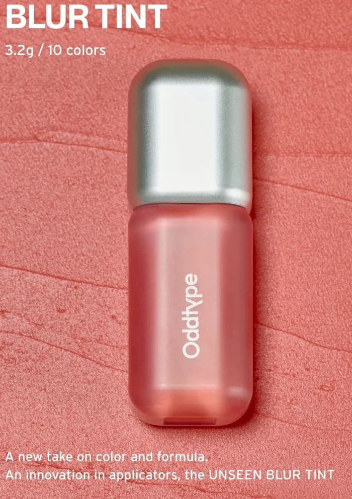 Pink lip tint with silver cap on a pink background, featuring the brand 'Oddtype'.