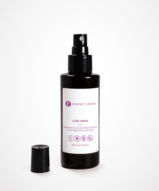 A black spray bottle of Perfect Locks Perfect Curl Defining Spray stands upright with its cap to the side on a white background.