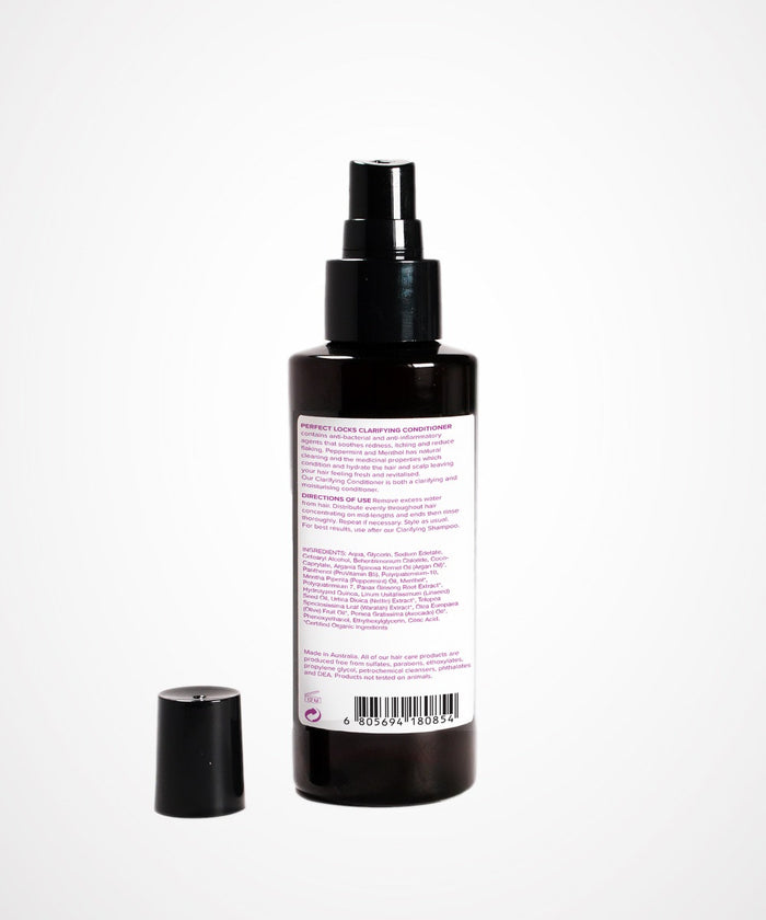 A dark spray bottle with a black pump and separate cap, labeled "Perfect Curl Defining Spray" by Perfect Locks for hair extensions.