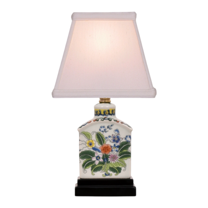 Decorative table lamp with floral design on a white background
