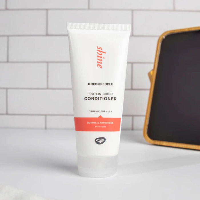 Protein-Boost Conditioner on a white bathroom vanity with tile background and small mirror stand.