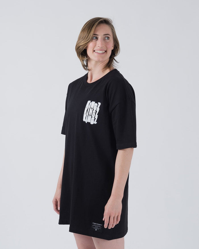 Kingz Quake Tee Black - Three-Quarter Body Side View Female Model Black Tee Bold White KINGZ Text Chest Minimalist Design Streetwear Apparel [color:Black]