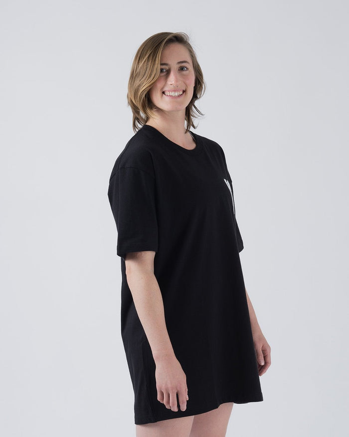 Kingz Quake Tee Black - Side View Female Model Relaxed Fit Short Sleeve Black Tee Subtle Front Logo Minimalist Streetwear Style [color:Black]
