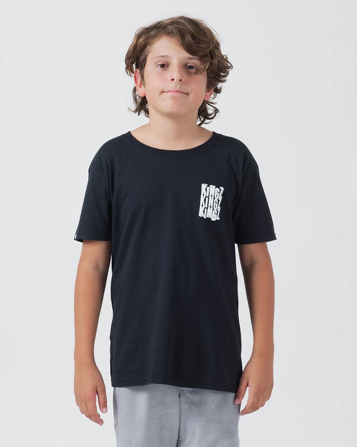 Kingz Quake Youth Tee Black - Front View Young Male Black Tee White KINGZ Repeated Logo Left Chest Casual Fit Short Sleeve Streetwear [color:Black]