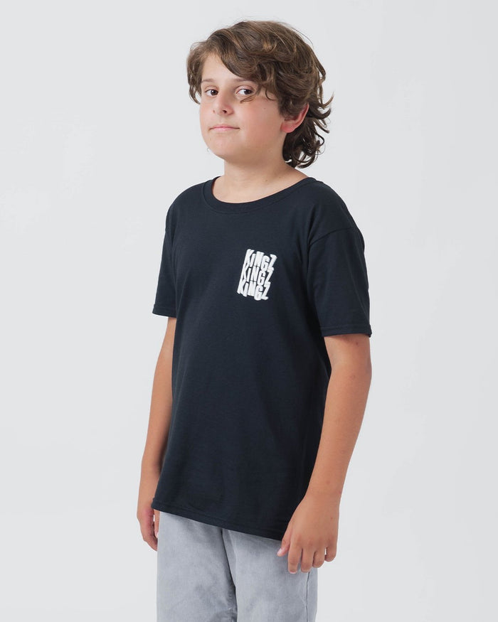 Kingz Quake Youth Tee Black - Front View Youth Model Black Tee Repeated KINGZ Text Left Chest Casual Fit Streetwear [color:Black]