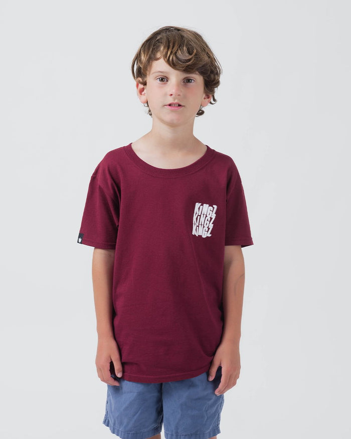 Kingz Quake Youth Tee Maroon - Front View Young Male White Repeated KINGZ Text Left Chest Short Sleeve Casual Fit Streetwear [color:Maroon]