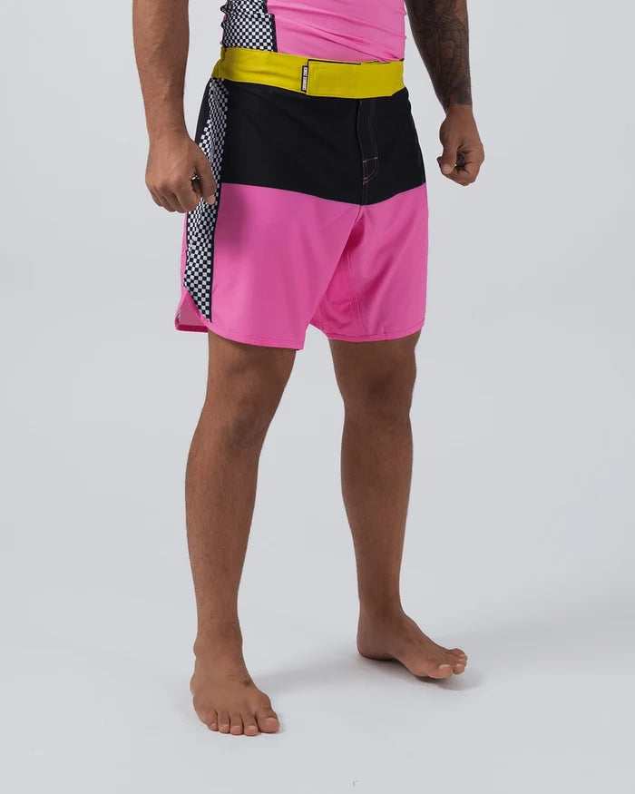 Kingz Retro Shorts Hot Pink Black Yellow - Full Body Right Side Profile Male Athlete Retro Color Block Grappling Shorts Black Upper Panel Hot Pink Lower Panel Yellow Elastic Waistband Black White Checkerboard Right Side Insert Matching Pink Rashguard Bare Feet Men's No-Gi BJJ Retro Collection [color:Hot Pink/Retro]