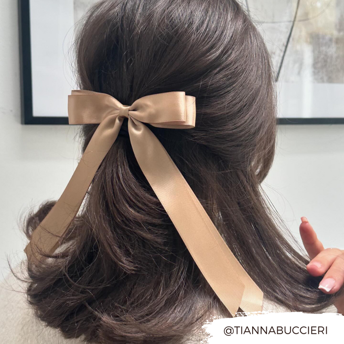 Wavy brown hair styled half-up with a caramel nude ribbon bow clip from Coconut Lane.