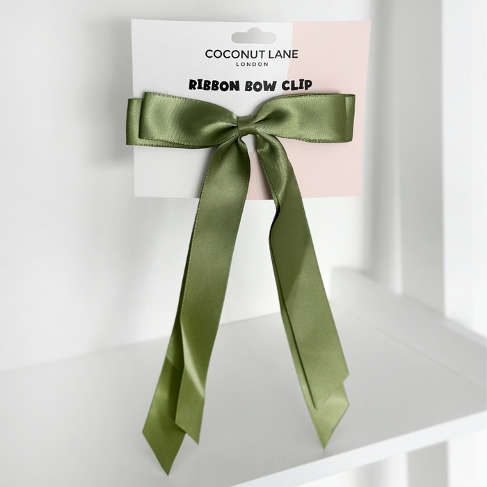 Olive green satin ribbon bow hair clip on a Coconut Lane display card.