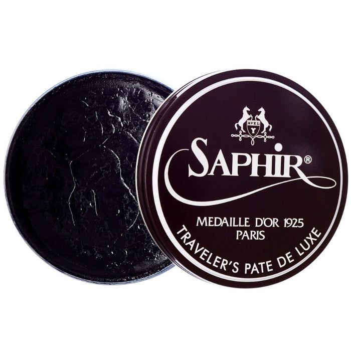 A black tin with the word KirbyAllison.com on it containing Saphir Traveler's Pate de Luxe wax shoe polish.