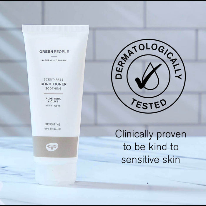 Tube of Green People conditioner with dermatologically tested logo and text on a blurred background.