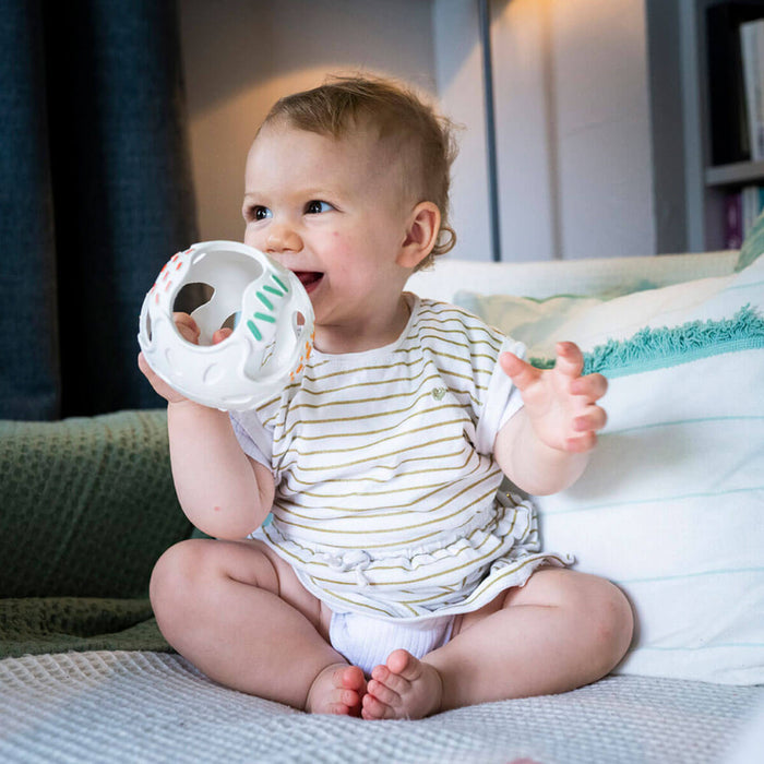 baby using sensory teething ball
