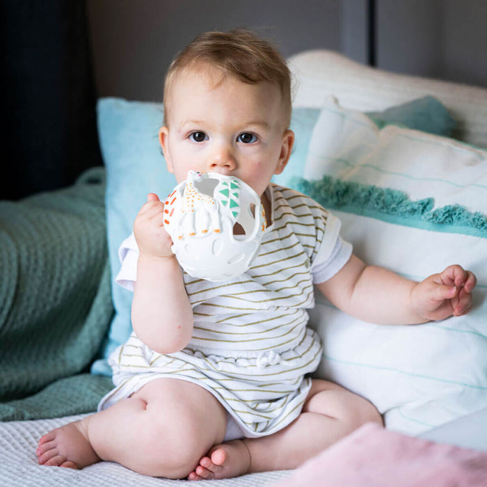 baby with teething sensory ball from sophie la girafe