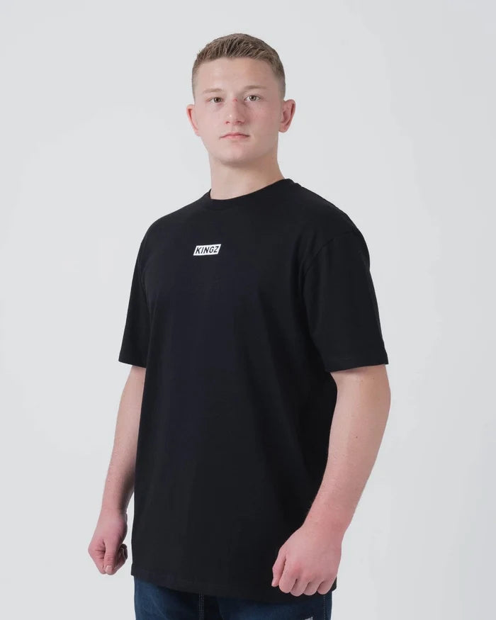 Kingz Slant Bar Tee Black - Front View Male Athlete Black T-Shirt KINGZ Logo Chest Simple Design Relaxed Fit Casual Wear BJJ Training [color:Black]
