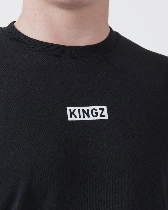 Kingz Slant Bar Tee Black - Close-Up Front View Black T-Shirt White KINGZ Text Center Chest Minimalist Design Casual Wear BJJ Training Apparel [color:Black]