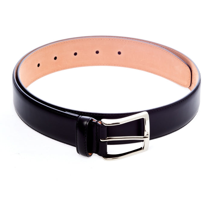 A handcrafted Sovereign Grade Black Calfskin Dress Belt from KirbyAllison.com on a white background.