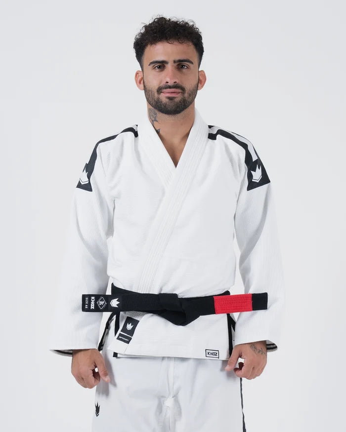Kingz Sport Jiu Jitsu Gi White - Front View Male Athlete Black Shoulder Patches Crown Badge Black Belt Kingz Logo Hem Durable Fabric Traditional Fit BJJ Gi Training [color:White]