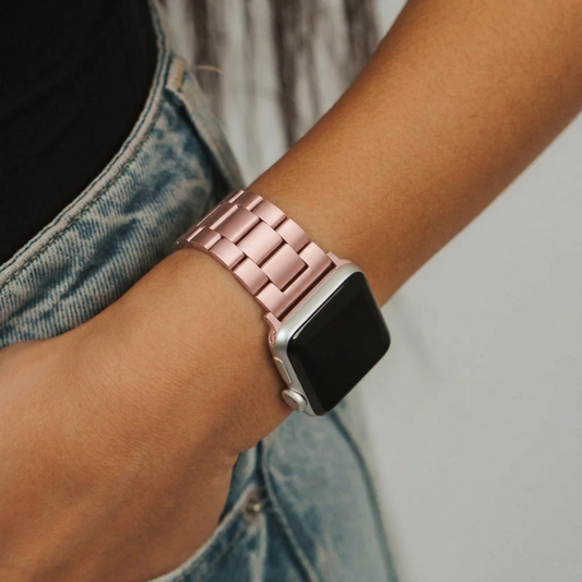 Girl with hand in jean pocket wearing stainless steel watch strap in blush