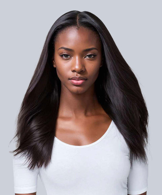 A woman with long, straight, Natural Black  hair enhanced by Perfect Locks extensions wears a white top, looking confidently.