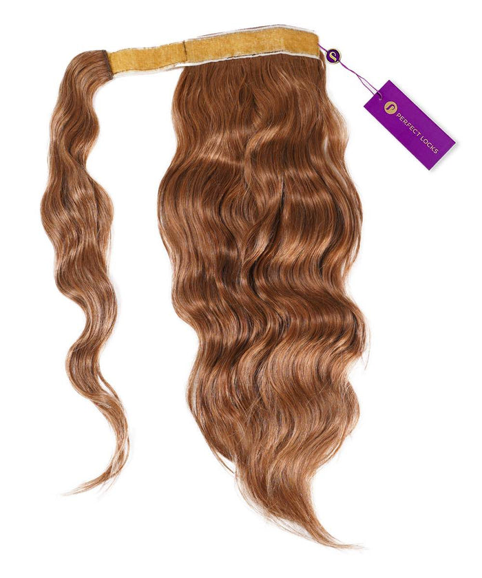 A wavy, golden brown  Wavy Clip-In Ponytail Extension from Perfect Locks with a pale yellow band and purple tag attached.#color_golden-brown-(6)
