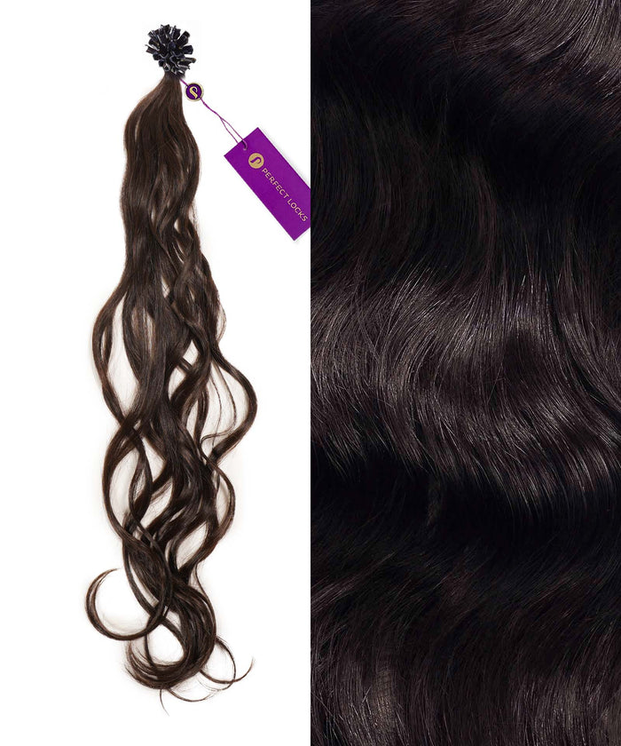A bundle of long, wavy dark brown hair extensions with a purple tag on the left; close-up highlights shiny, natural texture on right.