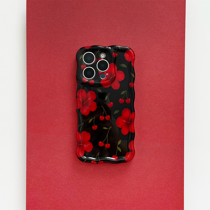 Wavy-edge phone case with red flowers and cherries on a bold red background.