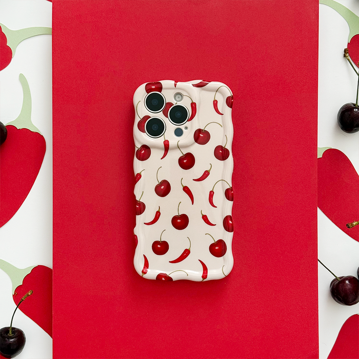 Cherry Spice wavy phone case by Coconut Lane on red background featuring cherry and chili pepper patterns.