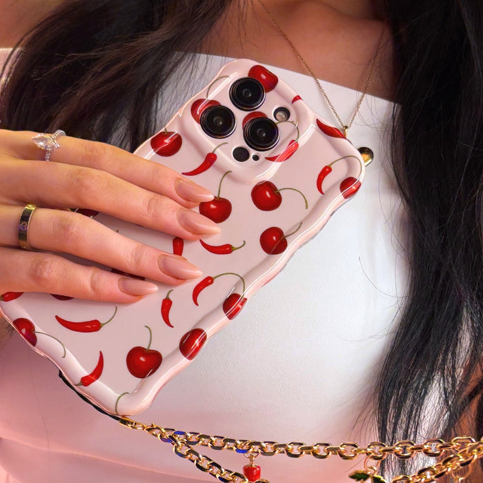 Coconut Lane Cherry Spice wavy phone case held in hand with manicured nails and rings visible.