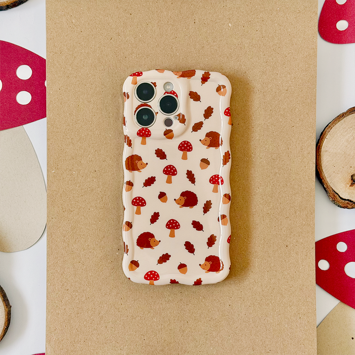 Coconut Lane wavy phone case with woodland animal print, displayed on a brown paper background.