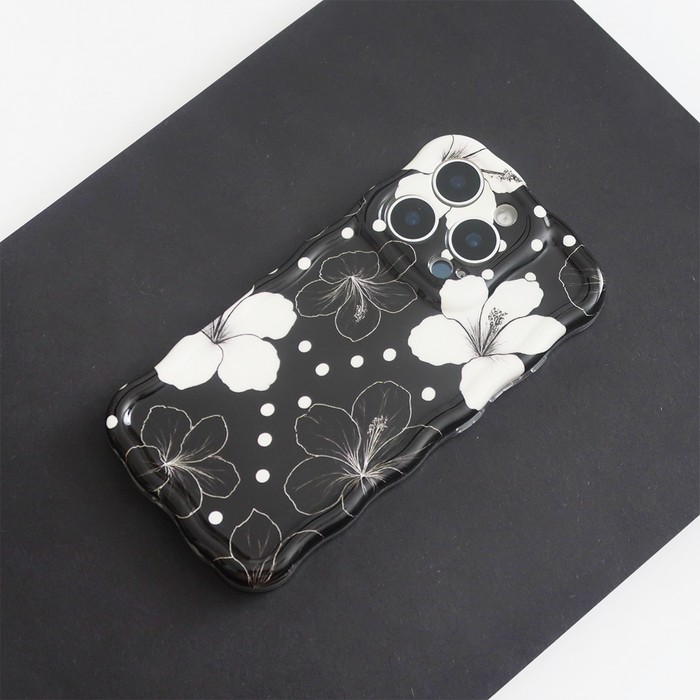 Black phone case with white hibiscus flowers and polka dots, Wavy Phone Case - Mono Flora by Coconut Lane.