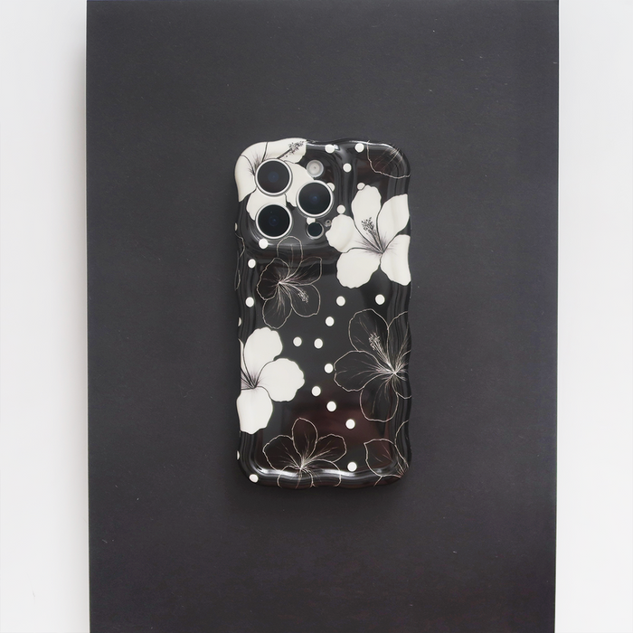 Wavy phone case with white hibiscus flowers and polka dots on a dark background.