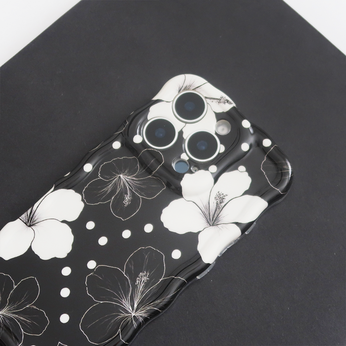 Black phone case with white floral and dot pattern, The Wavy Phone Case - Mono Flora by Coconut Lane.