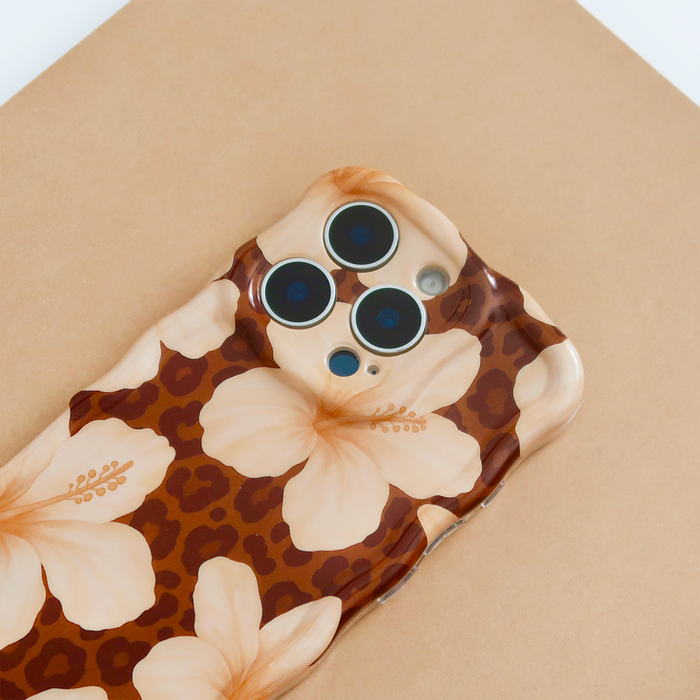 Safari Bloom wavy phone case with colorful pattern on a smartphone, displayed on a brown surface.