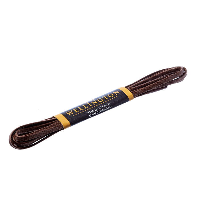 A Wellington Flat Waxed Dress Shoelace with a black stripe for dress shoes by KirbyAllison.com.
