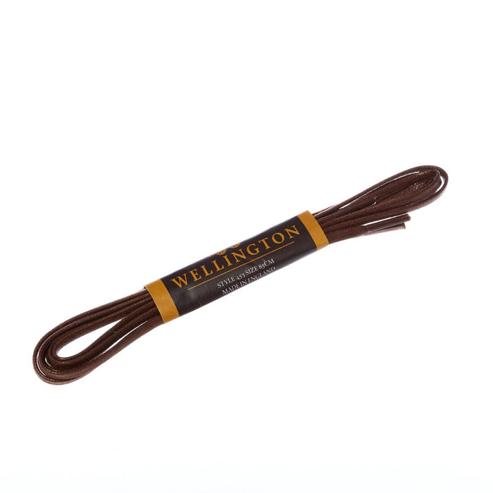 A Wellington Flat Waxed Dress Shoelace for dress shoes on a white background by KirbyAllison.com.